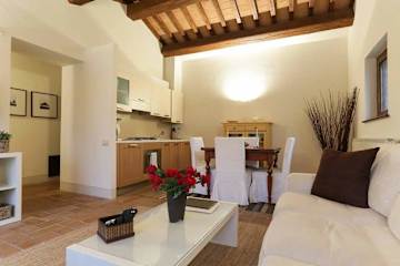 Cream sofa and coffee table near kitchen units