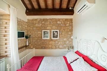 Metal bed with check blanket and pillows
