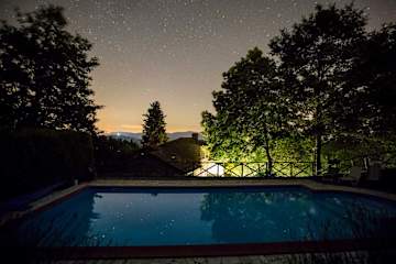 Aerial view of a house in Tuscany with garden and pool