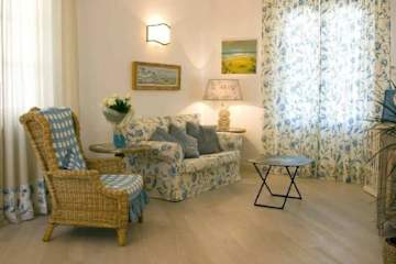 Floral sofa and wicker armchair