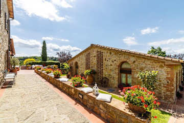 Flowerbeds in front of apartment building in Tuscany