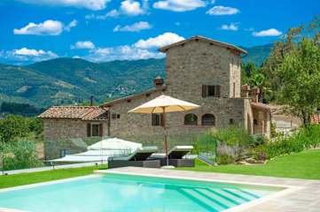 Swimming pool in garden to the front of a farmhouse