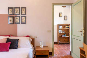 Bed with bedside table next to an open door