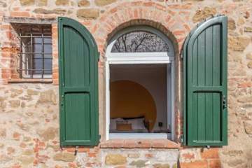 Arched window with green shutters