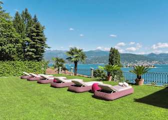 Sun beds on lawn overlooking a lake