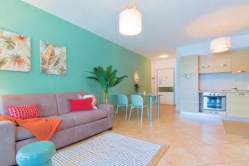 Pastel coloured open plan living room and kitchen