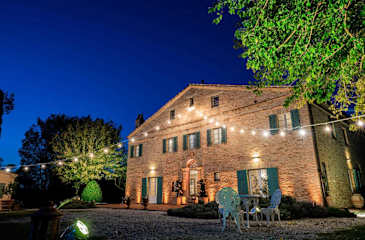 A traditional brick villa with green shutters