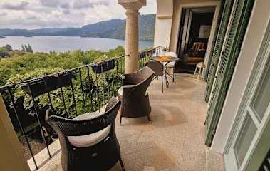 Chairs on a balcony overlooking a lake