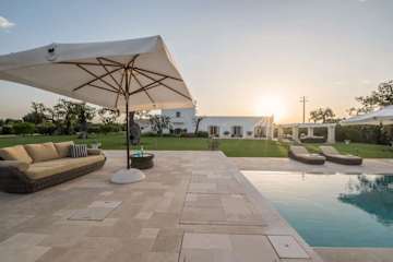 The sun setting over a swimming pool