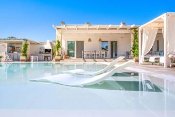 Two sun loungers at the edge of a pool