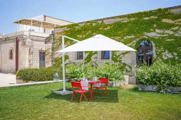 Two red chairs under a parasol