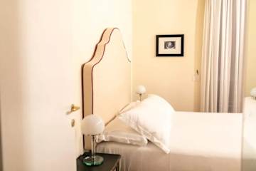 A bed with cream headboard
