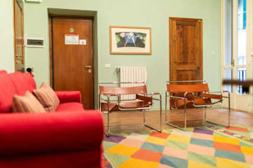 A living room with a colourful rug