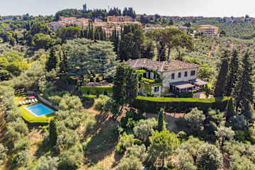 A traditional Italian villa surrounded by trees