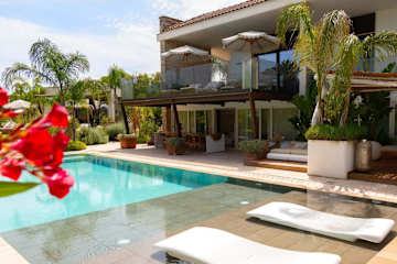 View down over a house with two swimming pools