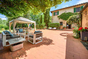Terrace with armchairs and a pergola