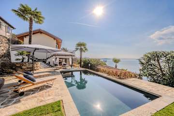 Stylish sun loungers next to a swimming pool