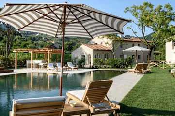 Poolside sun loungers under a parasol