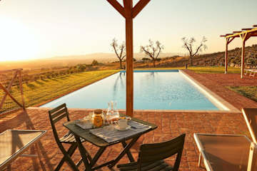 Wooden table next to a swimming pool