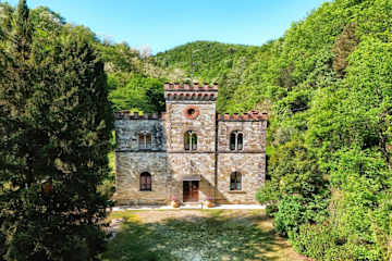 A stone house surrounded by trees