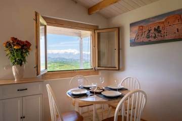 Round dining table next to a window