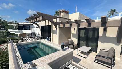 2nd floor deck with hot tub with a view of Los Arcos and Medano Beach