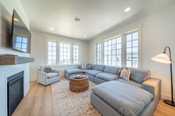 Light-filled living room with sectional seating and fireplace
