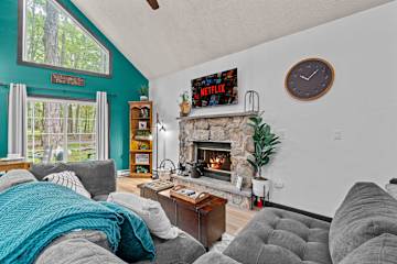 Cozy vibes, a crackling fire 🔥, and the comfort of the couch — perfect for a relaxing weekend getaway. #CabinLife