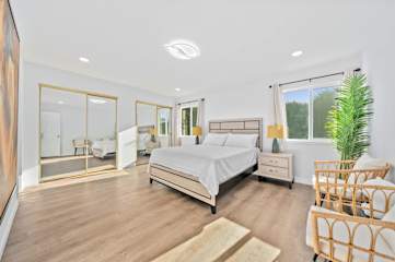 Cozy bedroom featuring a large mirror