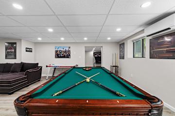 Head downstairs and let the group pick
their first fight — pool table vs. air hockey.
Your Game Zone has both, plus a sectional big enough for spectators and a Netflix screen for halftime.