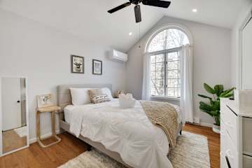 A serene sanctuary awaits. Luxurious bedding, natural light, and a touch of modern art create a peaceful escape. 🛌