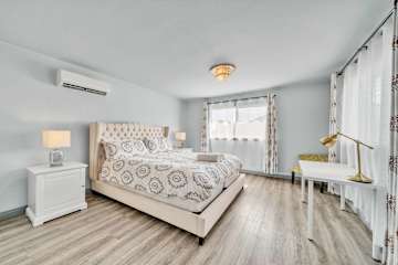 Cozy bedroom featuring a scenic window view