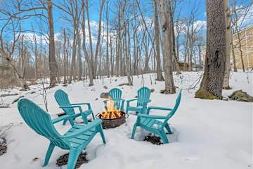 Laid-back vibes in the woods! These teal Adirondack chairs are ready for your fireside stories, laughter, and unforgettable memories.
