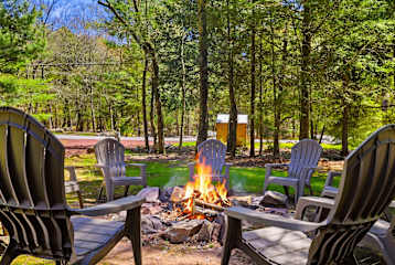 Gather the whole crew around the fire pit — six Adirondack chairs, a roaring fire, and pine trees as far as you can see. This is the conversation you'll be talking about on the drive home.