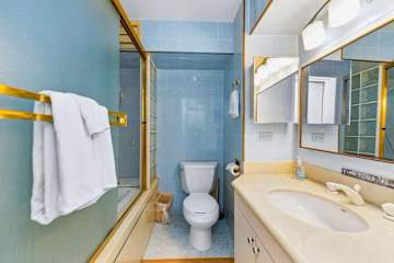 Well-maintained bathroom with enclosed shower and essentials