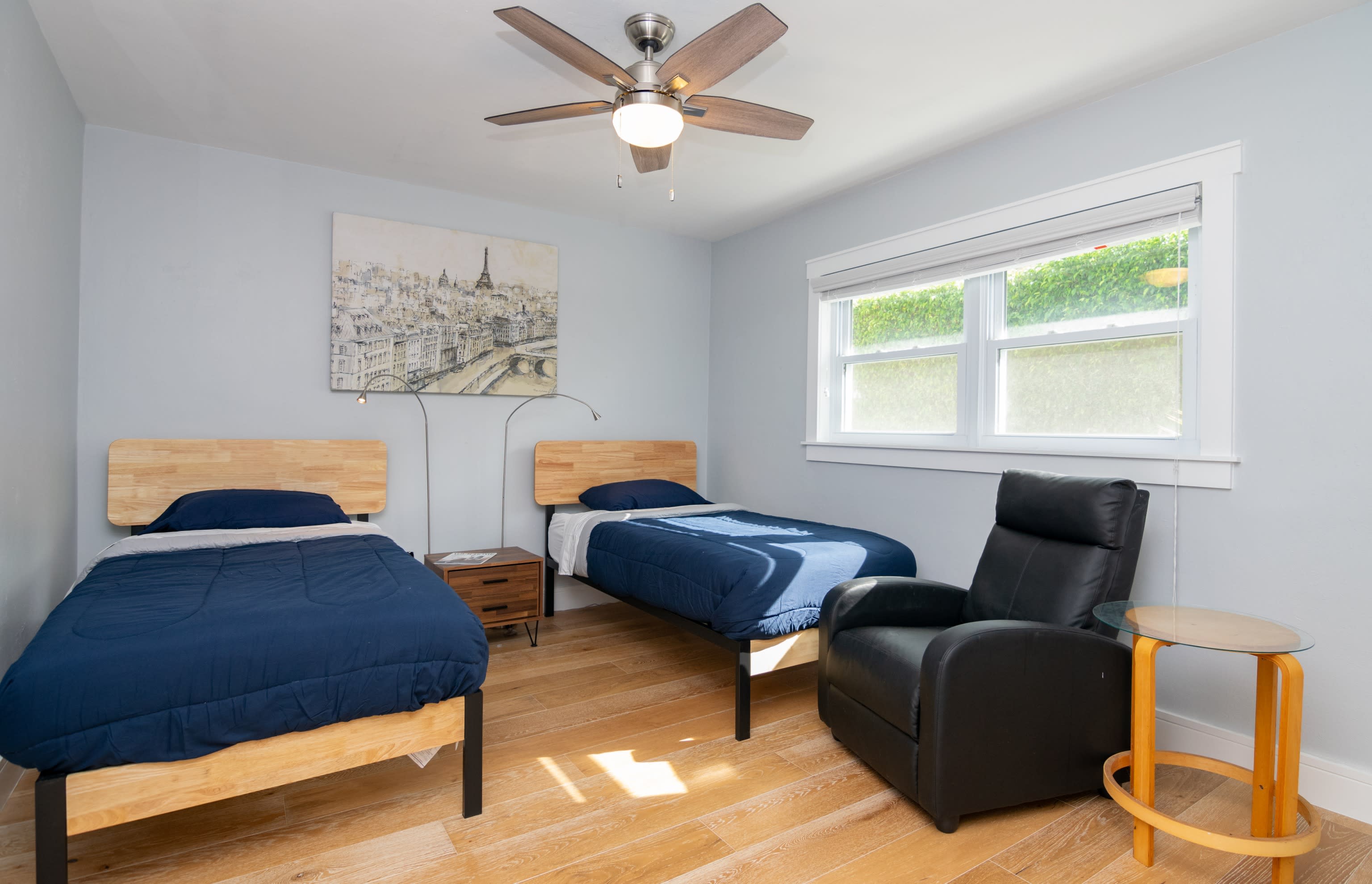 There are Reading Lights and a Chair and Table in the Third Bedroom