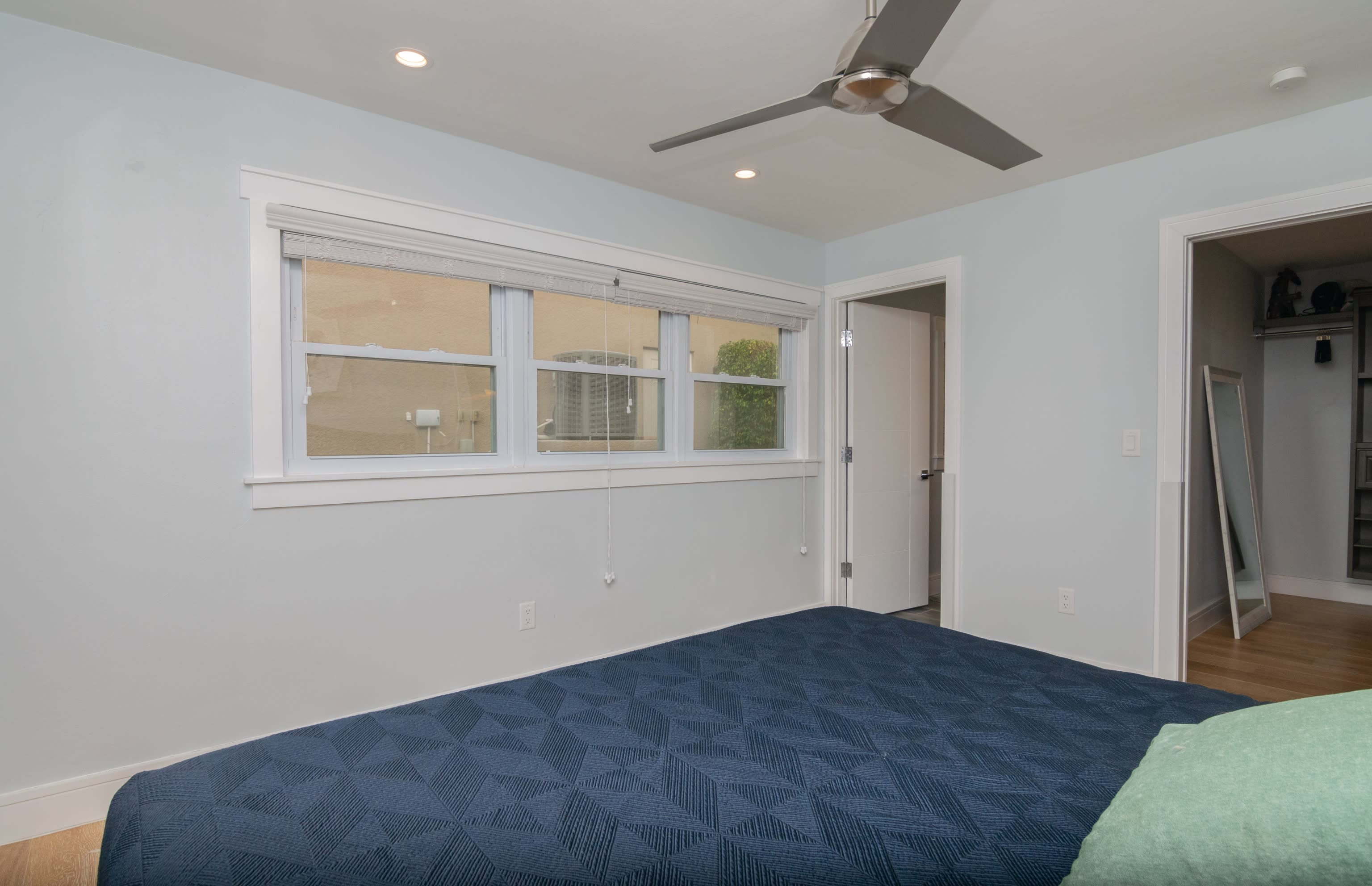 The King Bed in the Main Bedroom with Doors Leading to Closet and Main Bathroom