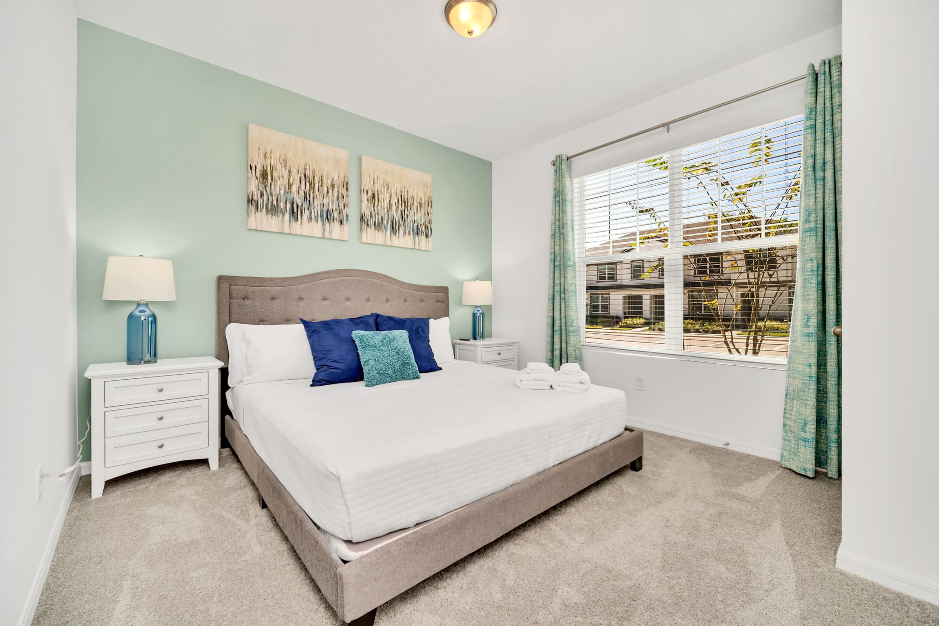 Bright Queen Bedroom With Chic Green Accents And Large Window