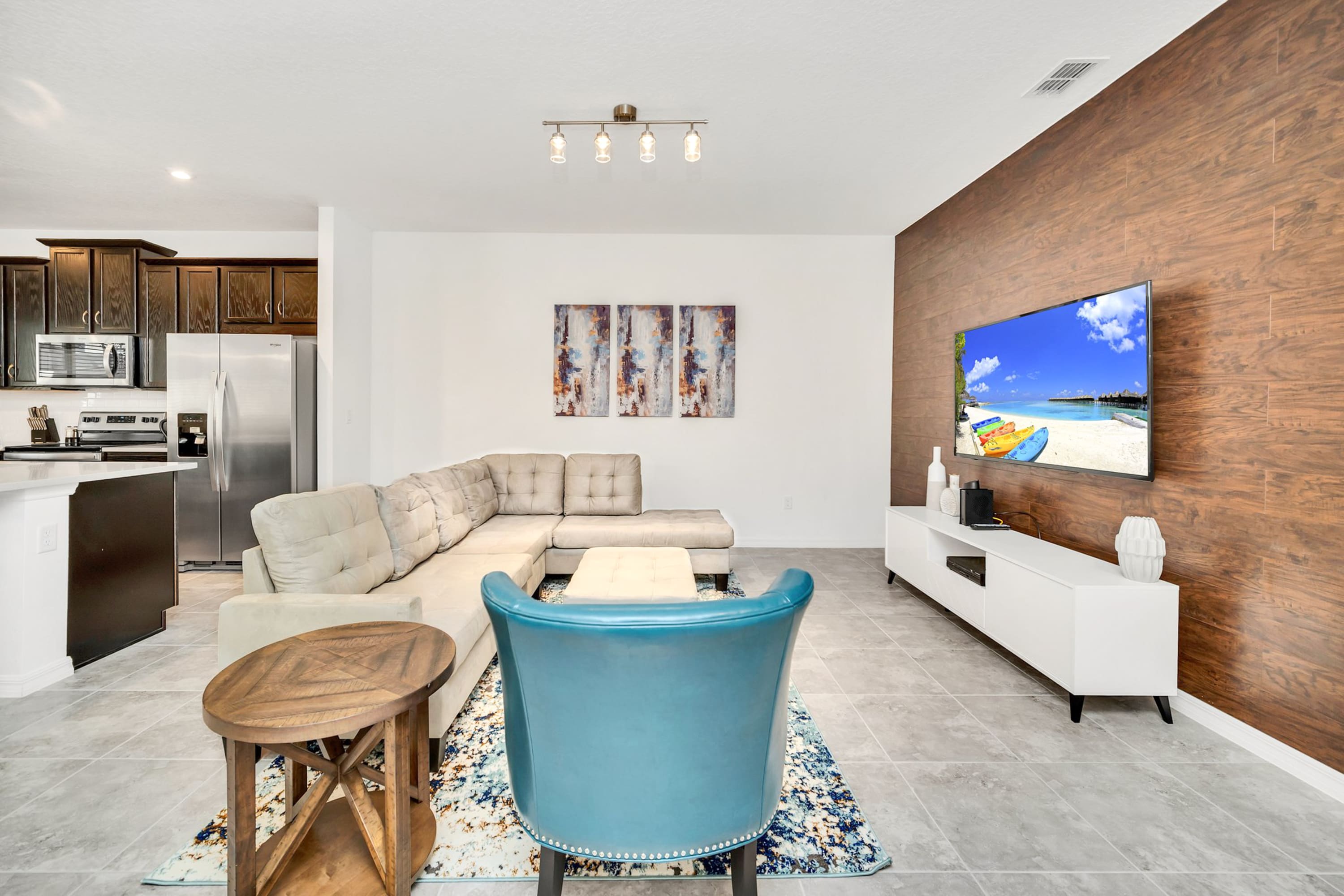 Relax In This Spacious Living Room With A Big Screen Smart TV