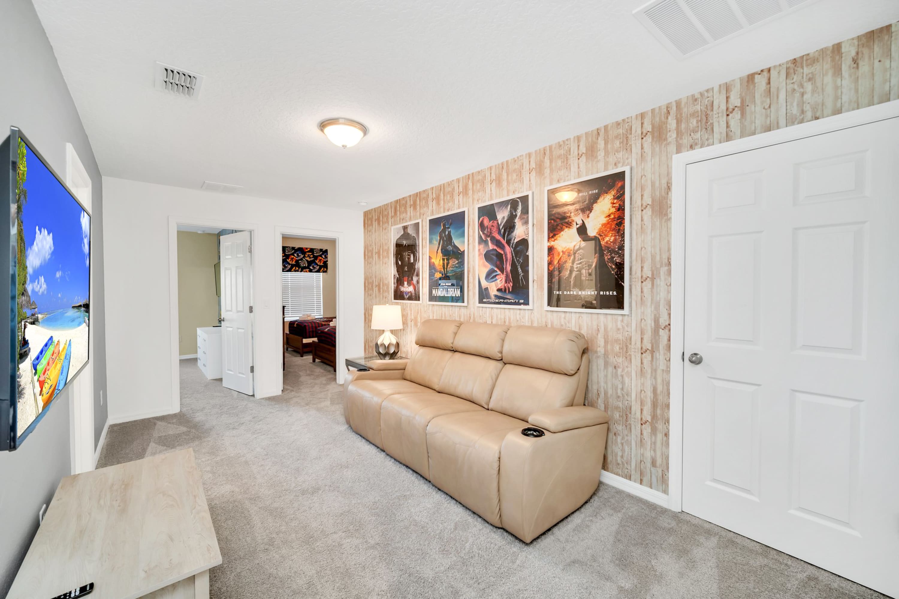 Comfortable Lounge Area With Bright Decor And Big Screen TV