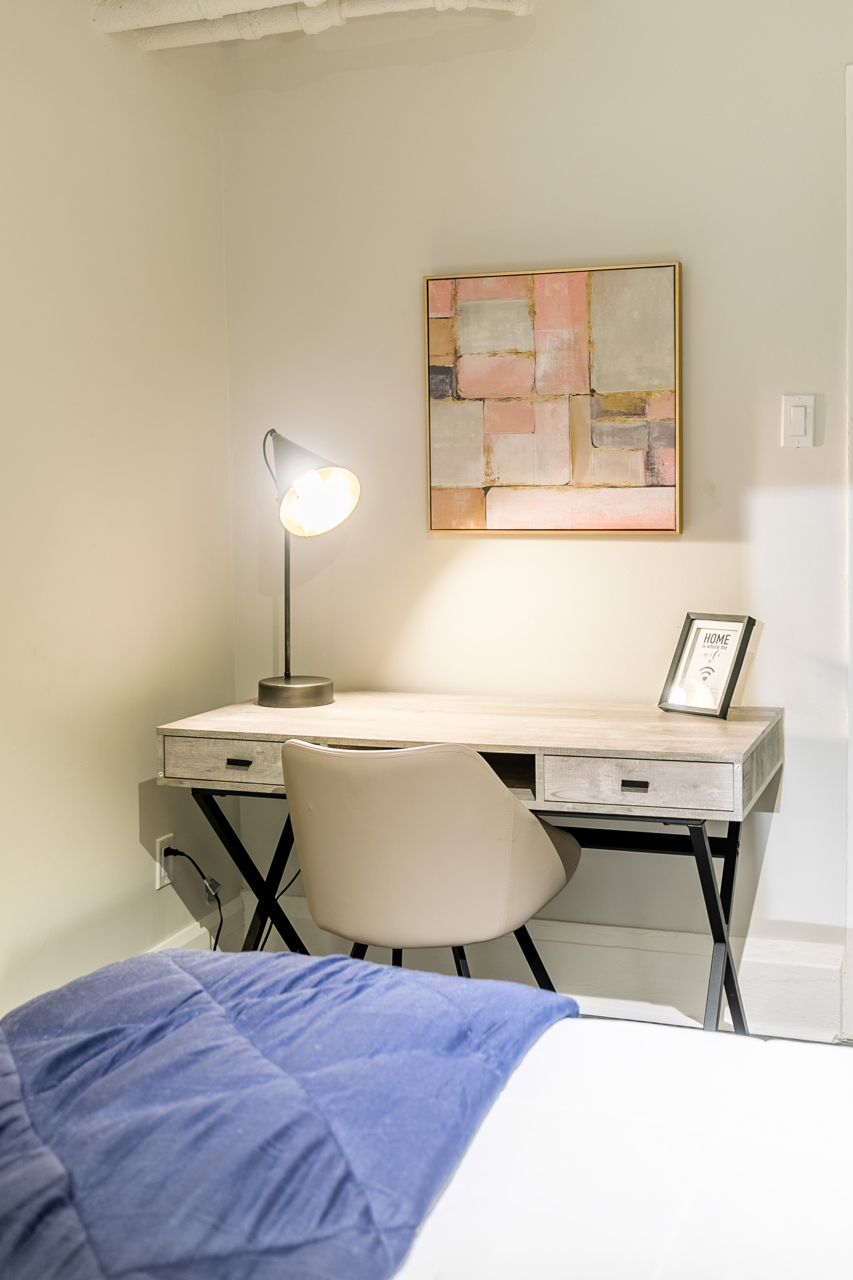 Elegant Bedroom With A Cozy Work Desk And Vibrant Decor