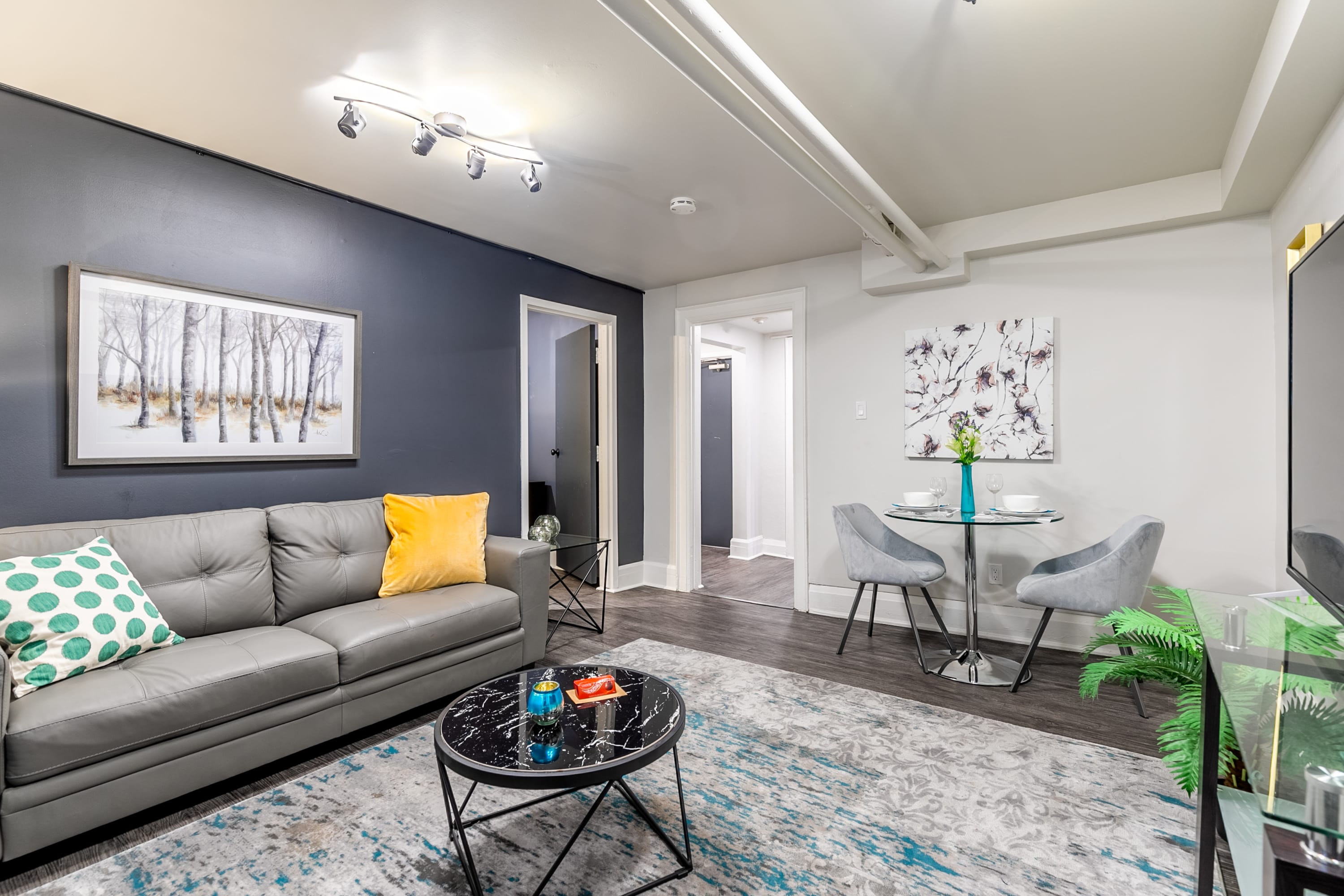 Inviting Living And Dining Area With Contemporary Art And Modern Furnishings