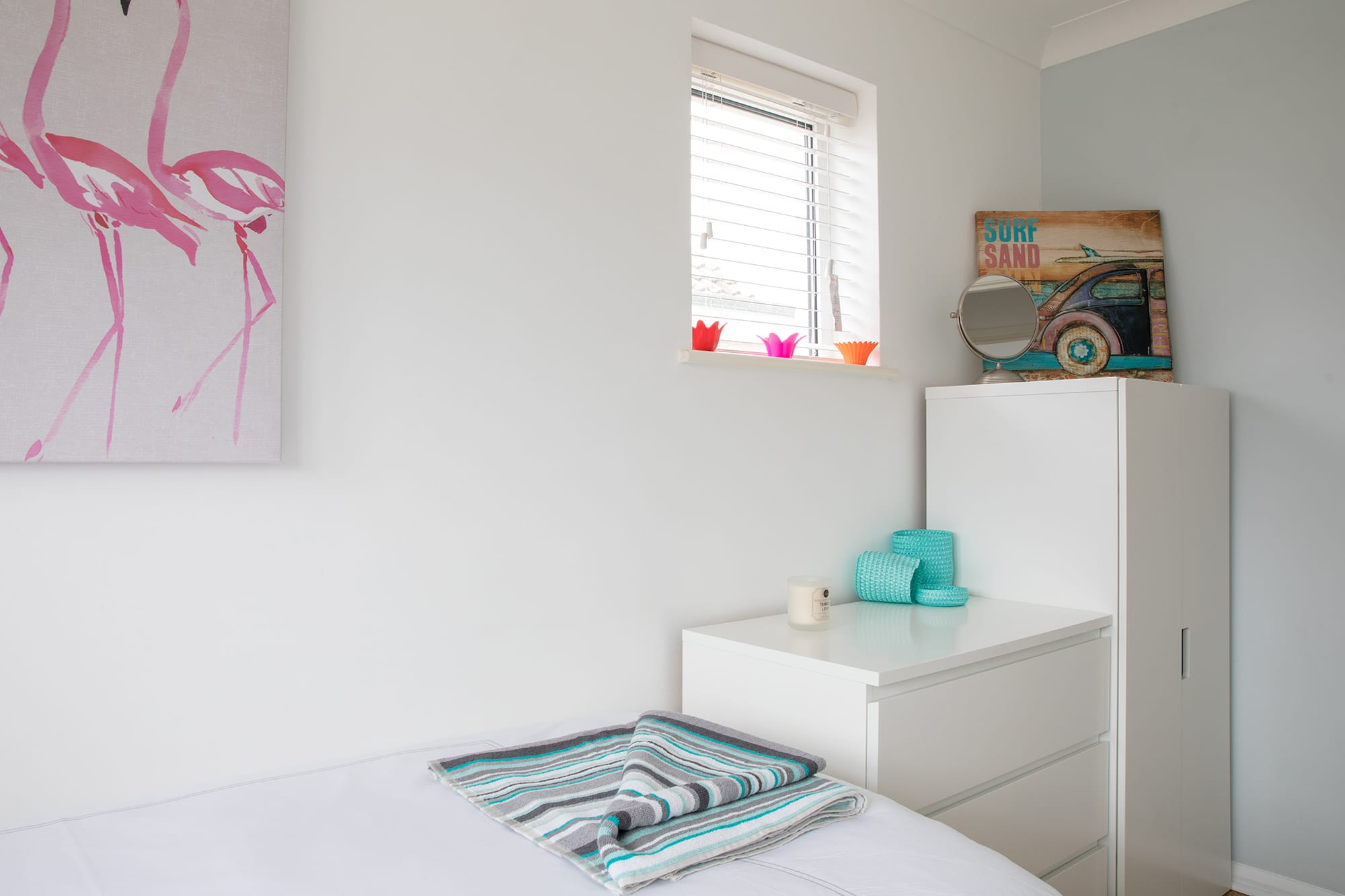 Small closet is paid with a dresser to offer plenty of storage space.