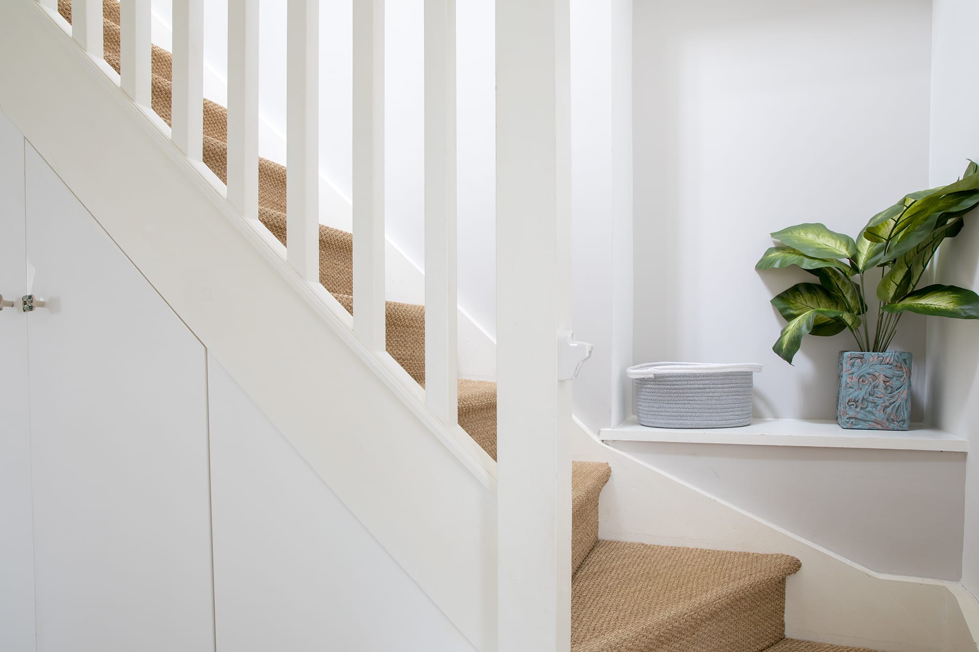 Climb up the carpeted staircase to reach the upper floor.