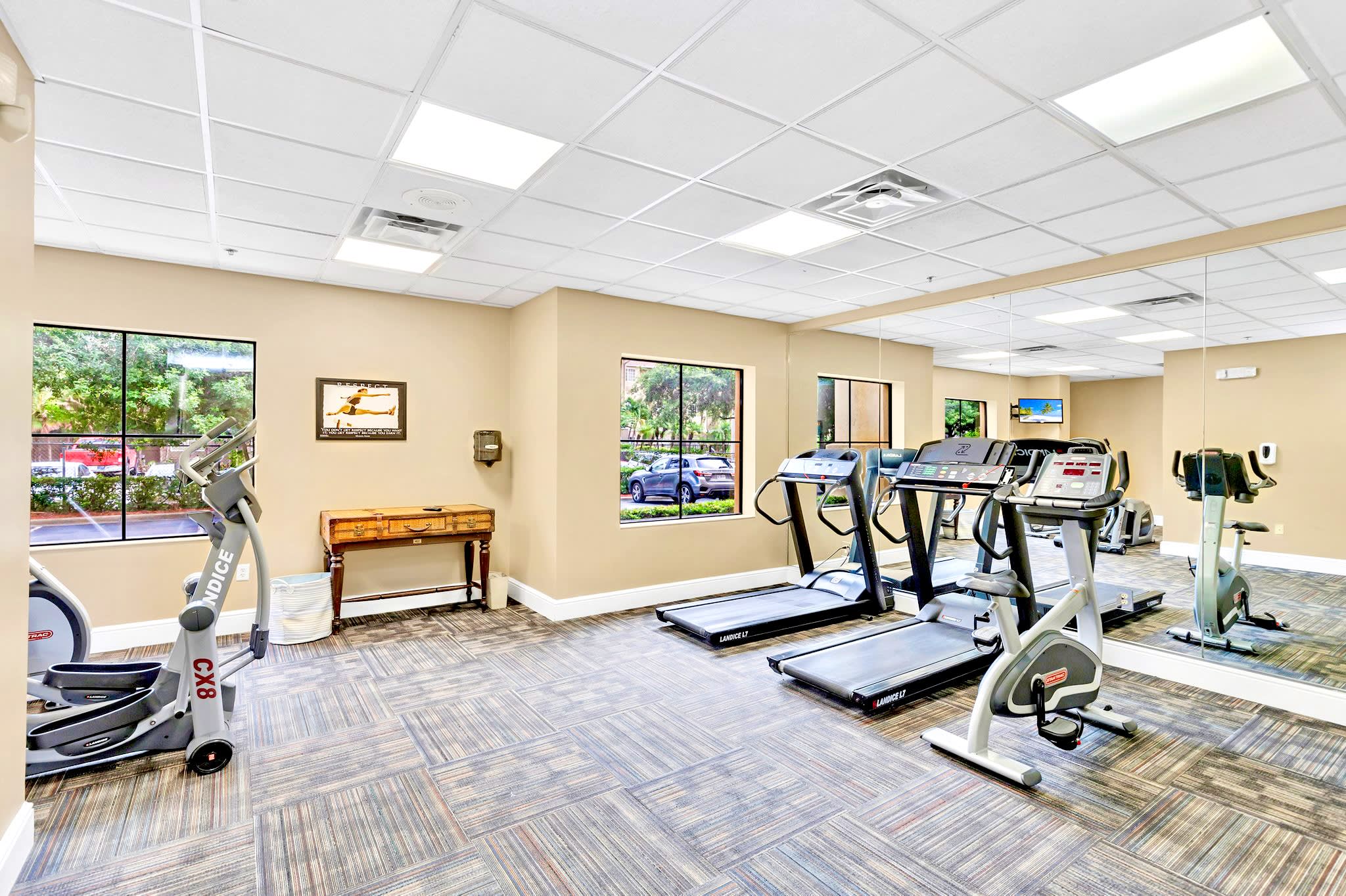Fully Equipped Fitness Center With Natural Light And Scenic Views