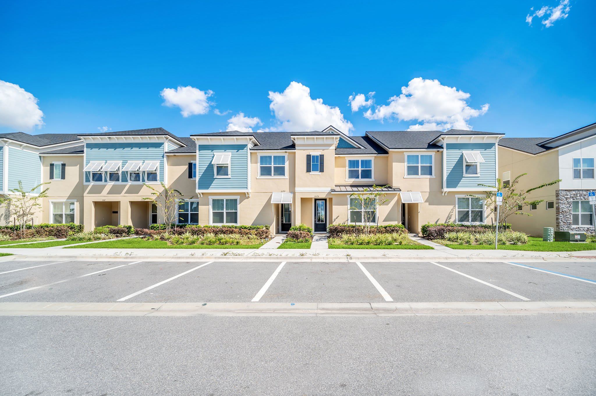 Stunning Townhome Exterior Highlighting Clean Design And Ample Parking