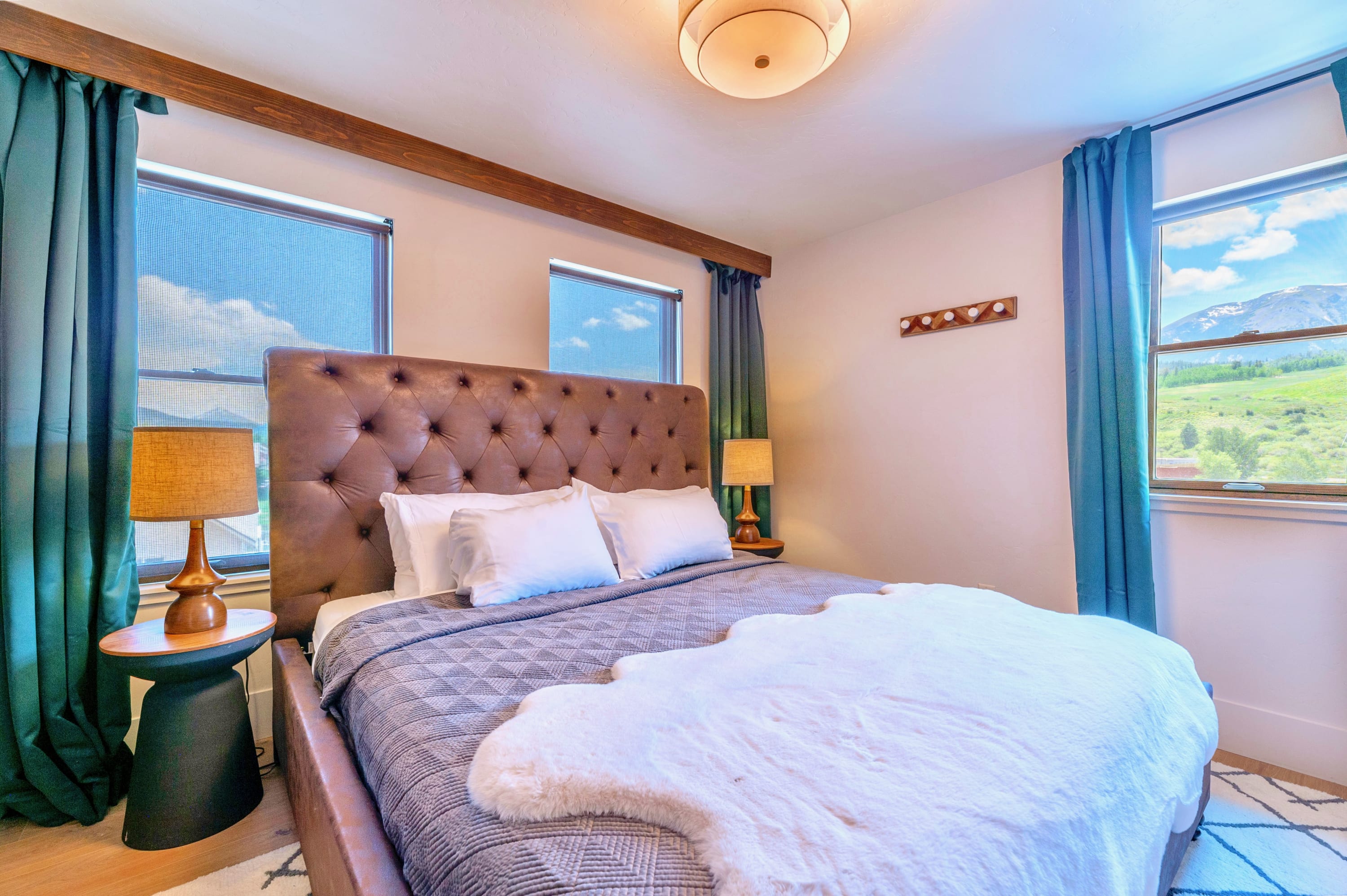 Elegant Bedroom Featuring A Comfortable Bed And Mountain Views