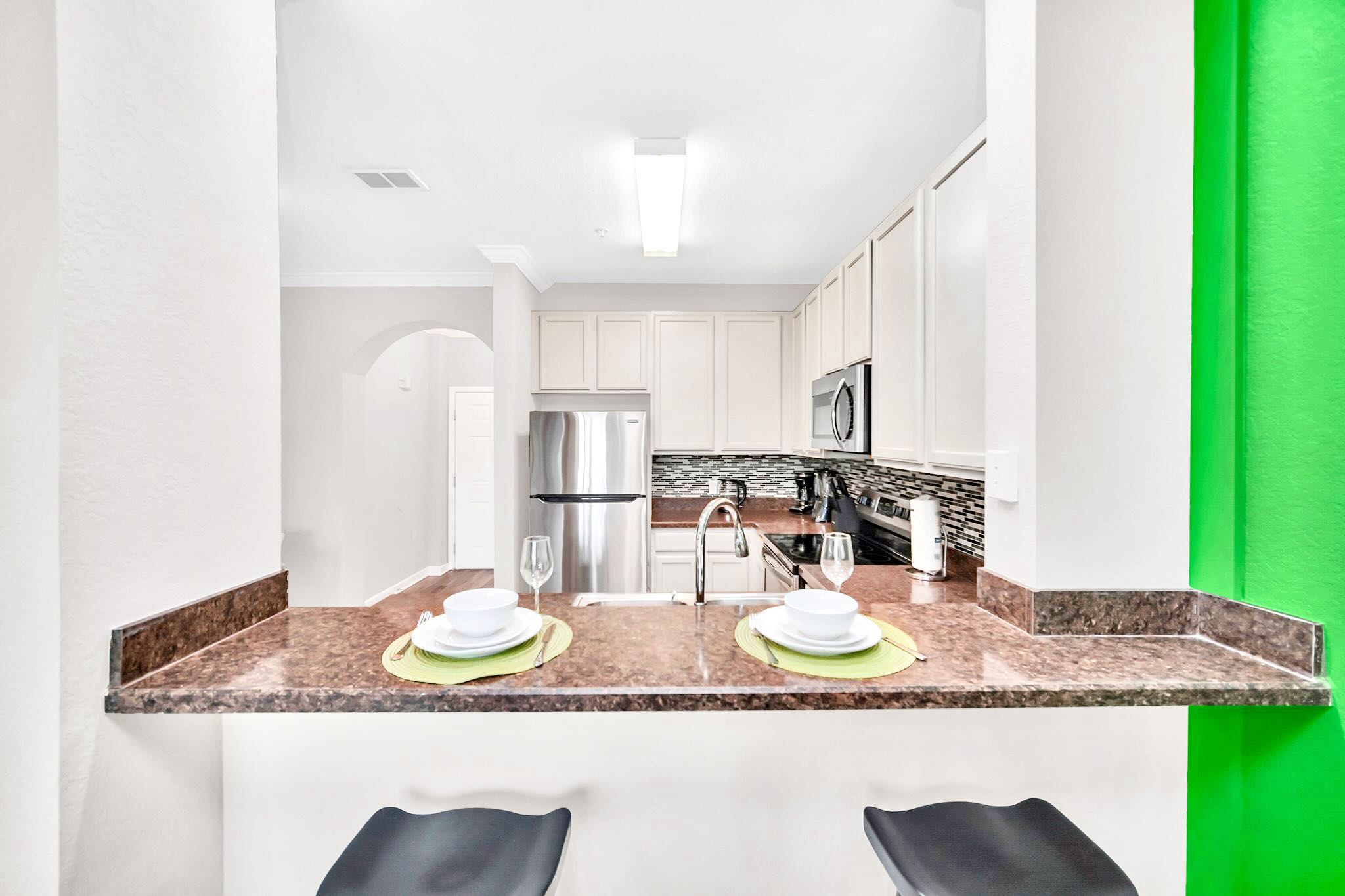 Fully Equipped Kitchen Featuring A Breakfast Bar And High-End Appliances