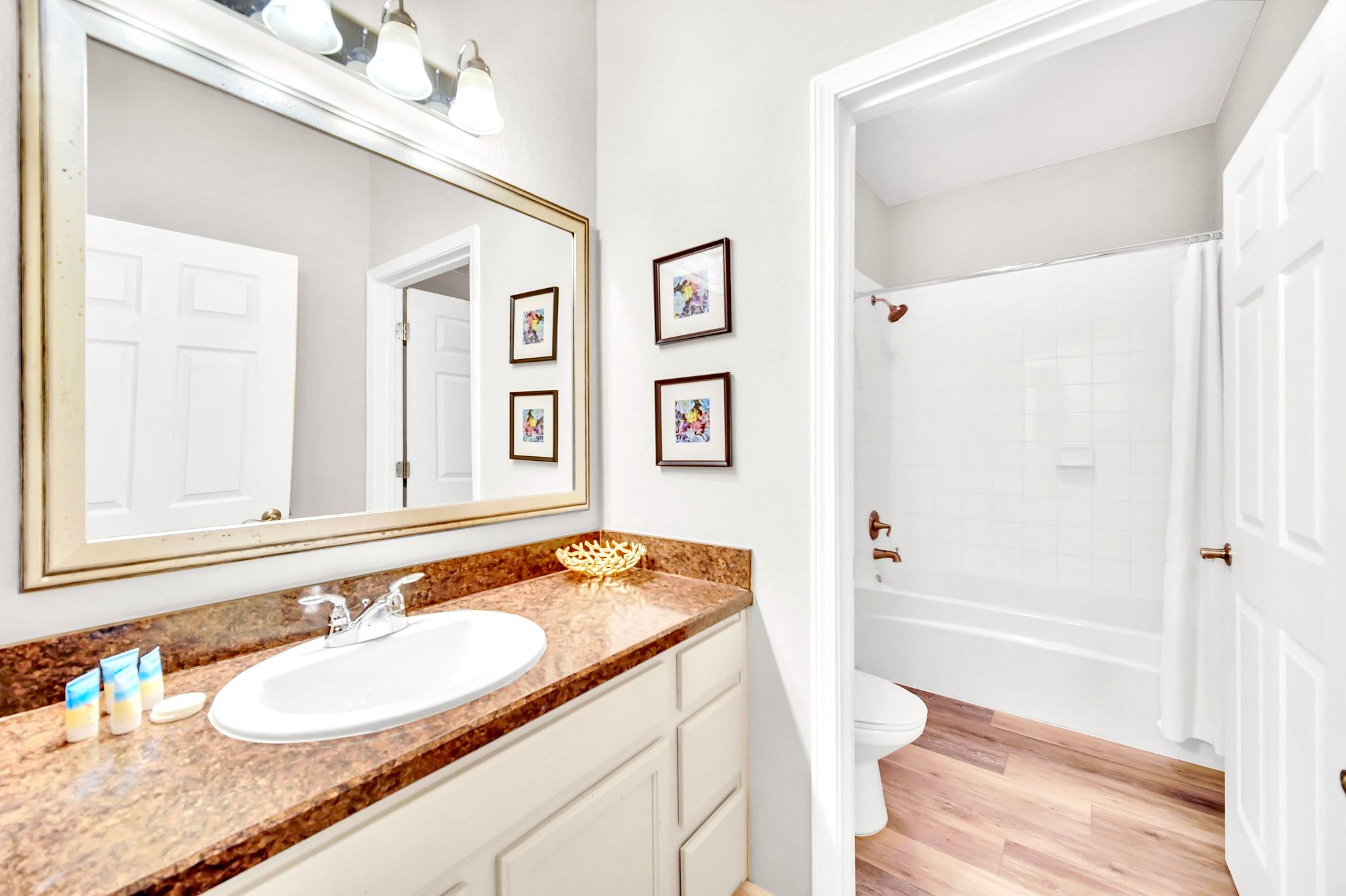 Shared Bathroom Featuring A Shower-Tub Combo And Modern Fixtures