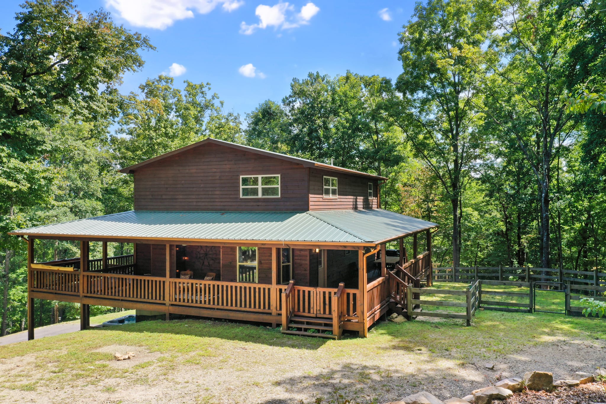 The cabin has a wrap around porch with gathes to keep your furry friends close, as well as a fenced in yard for them to roam!